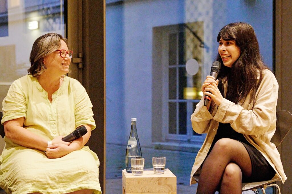 Mentee Simoné Goldschmidt-Lechner diskutiert auf dem Podium über Geschlechtergerechtigkeit in der Kunst.